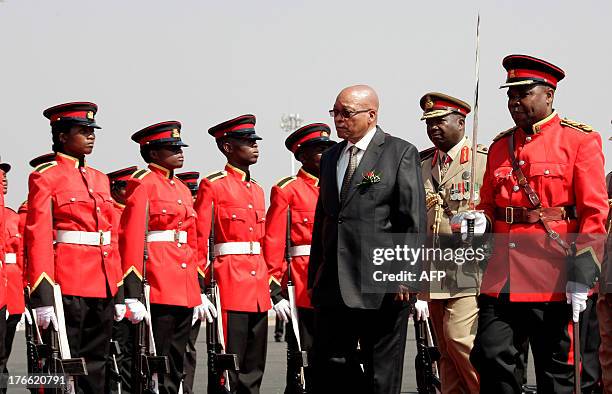 South Africa's President Jacob Zuma inspects a military parade on arrival at Kamuzu International Airport in Lilongwe, on August 16 ahead of the 33rd...