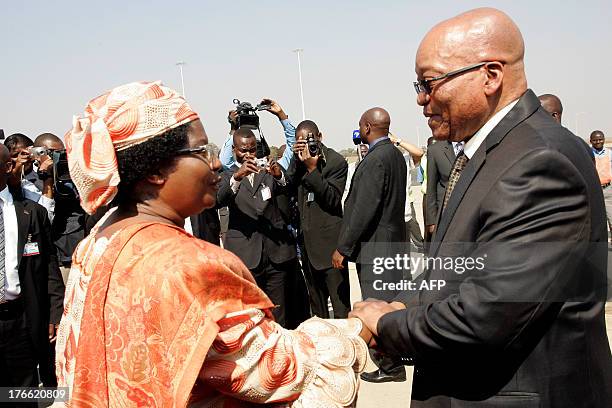 South Africa's President Jacob Zuma is welcomed by Malawi's President Joyce Banda at Kamuzu International Airport in Lilongwe, on August 16 ahead of...