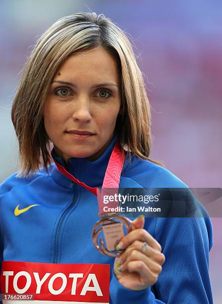 Bronze medalist Olha Saladuha of Ukraine stand on the podium during the medal ceremony for the Women's Triple Jump during Day Seven of the 14th IAAF...