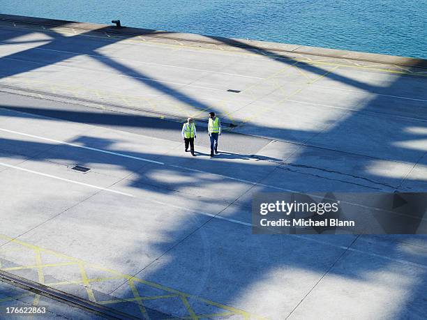 two workers talking in harbour seen from above - dock worker stock pictures, royalty-free photos & images