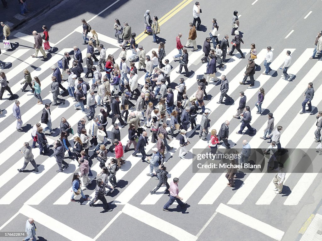 Commuters walking on zebra crossing