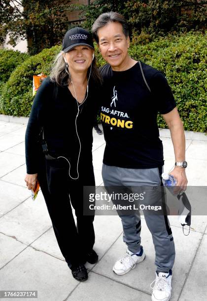 Julia Nickson and Peter Kwong are seen picketing as SAG-AFTRA Strike Continues at Warner Bros. Studios on October 23, 2023 in Burbank, California....