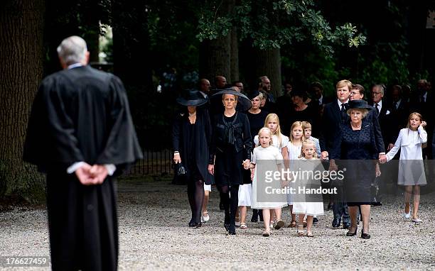 In this handout image provided by ANP, Princess Mabel of the Netherlands walks towards Rev Carel ter Linden with her daughters Countess Luana and...