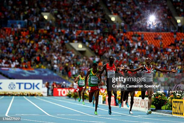 Mo Farah of Great Britain crosses the Line to win gold ahead of Hagos Gebrhiwet of Ethiopia and Isiah Kiplangat Koech of Kenya in the Men's 5000...