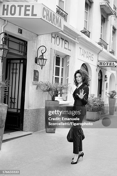 Actress Monica Bellucci is photographed for Madame Figaro on June 19, 2013 in Paris, France. Suit, shirt and bag , necklace and watch , shoes ....