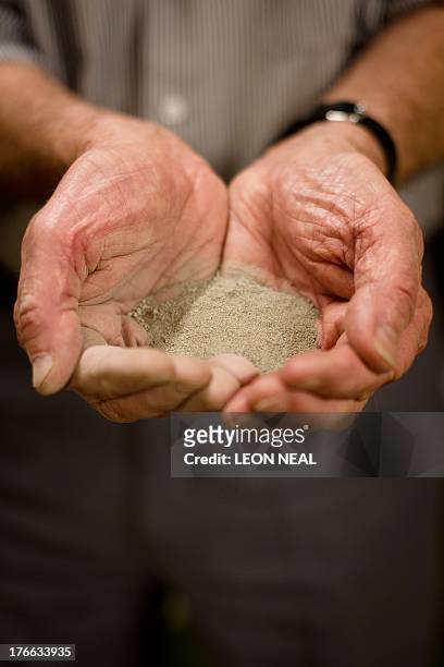 Mike Proudfoot, CEO of Marine Minerals Limited, holds a sample of tin-rich sea-bed sediment at the testing facility at the former Wheal Jane mine,...
