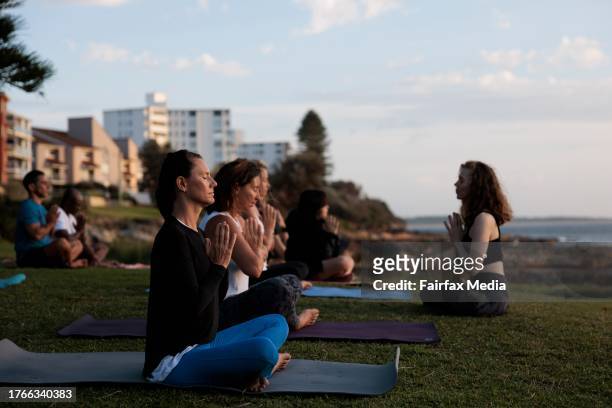 Shivani O'Brien takes an outdoor yoga class at Shelly Beach in Cronulla. A federal government sports survey shows more people are practicing yoga...