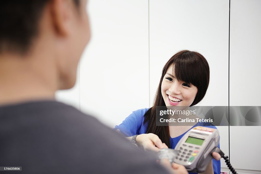 Cashier accepting credit card payment