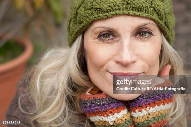 mature woman in warm clothing and knit hat, portrait - mature woman winter stock pictures, royalty-free photos & images