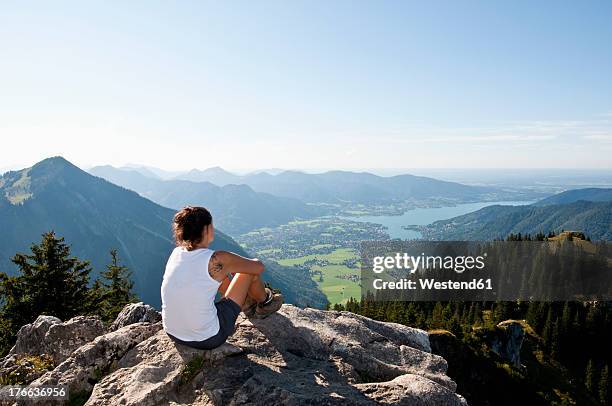 germany, bavaria, mid adult woman looking from bodenschneid to lake tegernsee - tegernsee imagens e fotografias de stock