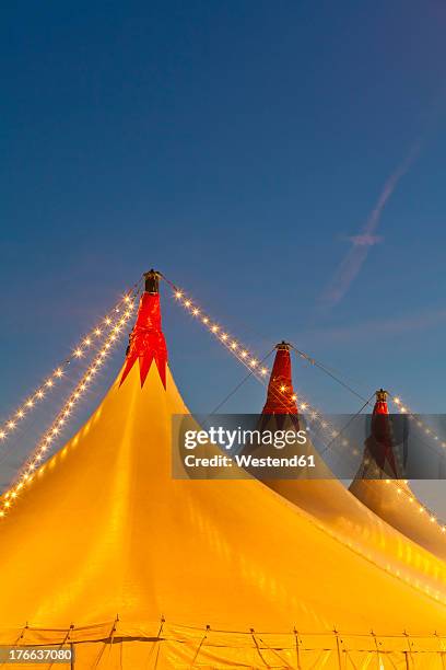 germany, baden wuerttemberg, stuttgart, big circus tent tops against sky - carpa de circo fotografías e imágenes de stock