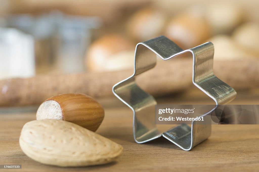 Various nuts with star shape cookie cutter for christmas on table