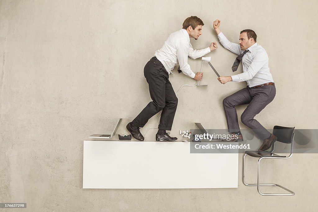 Businessmen fighting in office