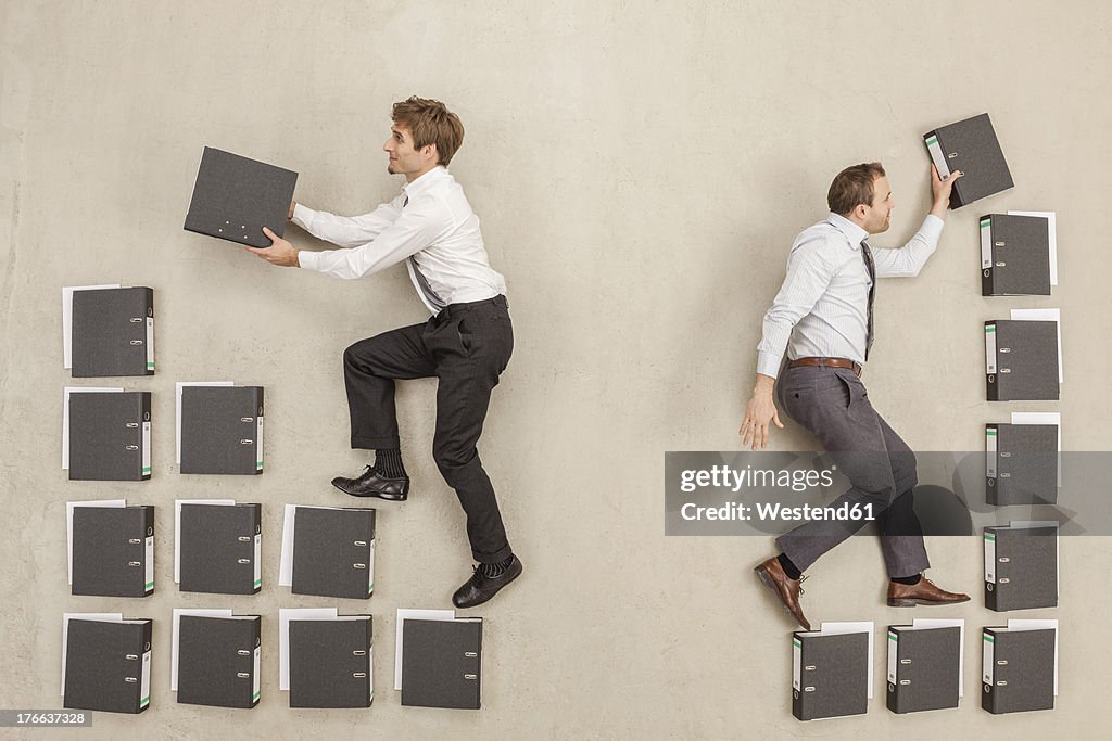 Businessmen arranging files in office