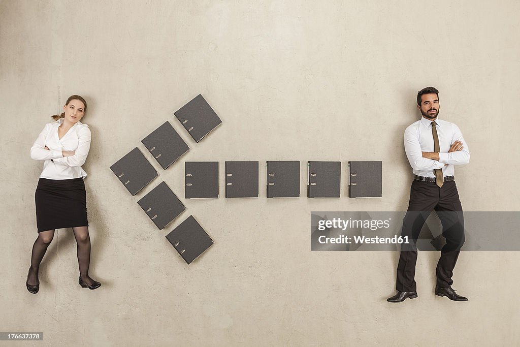 Files forming arrow sign between two business people