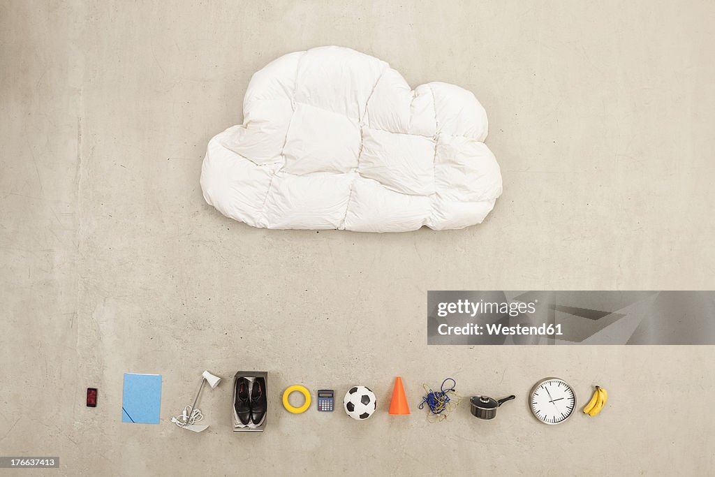 Cloud shape pillow with variety of items on beige background