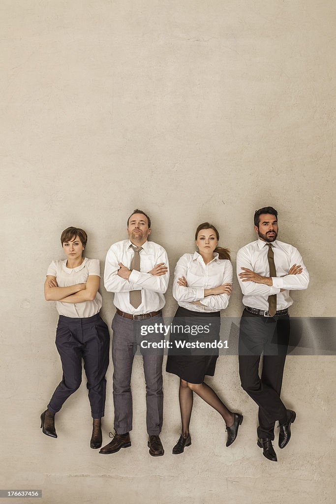 Business people standing side by side with arms crossed
