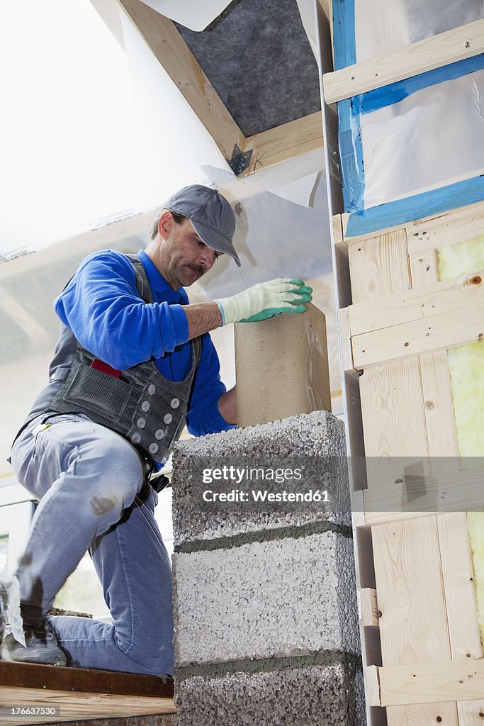 Europe, Germany, Rhineland Palatinate, Worker installing thermal insulation