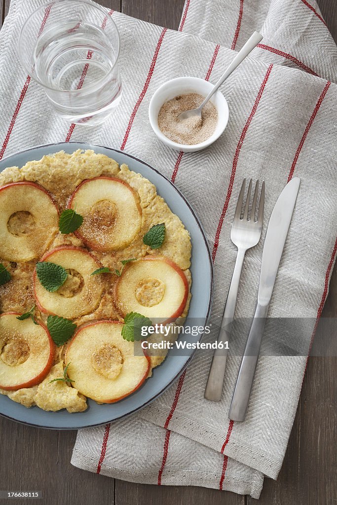 Apple and oat flakes pancake with sugar and cinnamon in bowl