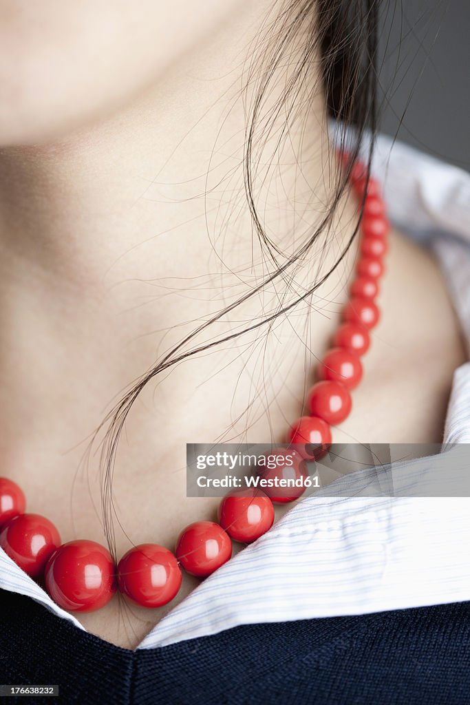 Japanese woman with red necklace, close up