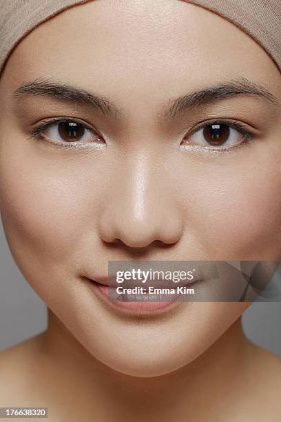 young woman with brown eyes looking at camera - face symmetry stock pictures, royalty-free photos & images