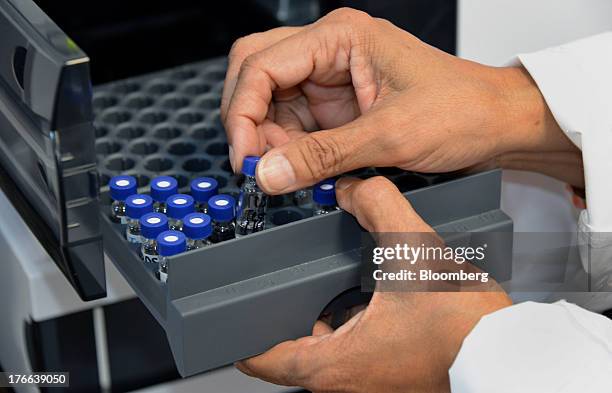 Rekha Shah, director of analytical sciences at Transdermal Delivery Solutions, installs test vials in a chromatographic column tester, in Palm Beach...