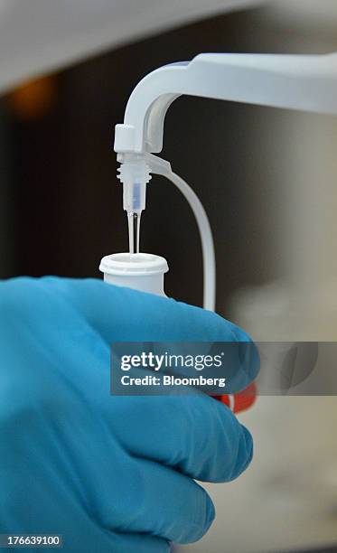 Ken Kirby, president of Transdermal Delivery Solutions, uses a calibrated dispenser to fill tester spray bottles of progesterone, in in Palm Beach...