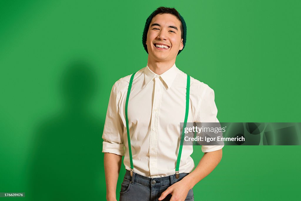 Portrait of young man wearing green braces