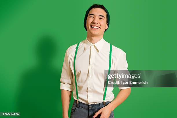 portrait of young man wearing green braces - suspenders stock pictures, royalty-free photos & images