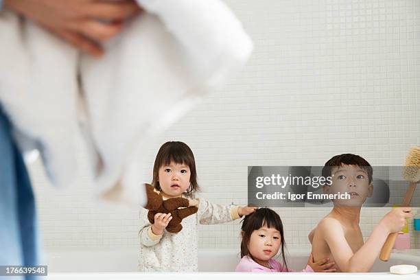 brother and sisters in bath playing - brothers bathroom stock-fotos und bilder