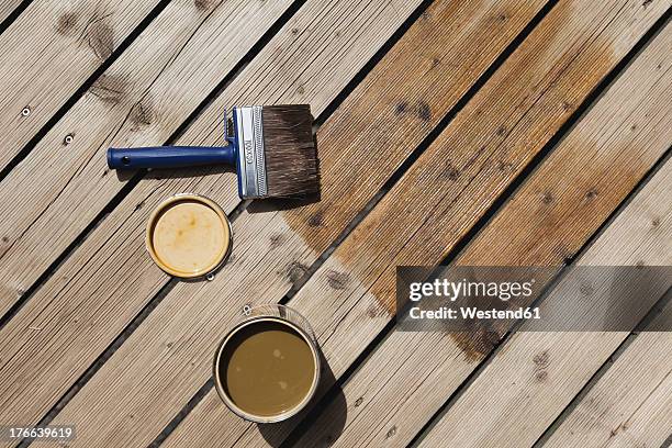 germany, cologne, wood panel with wood stain and paint brush - wood stain stock pictures, royalty-free photos & images