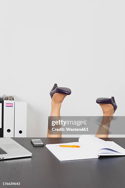business woman overturning behind office desk - upside down stock pictures, royalty-free photos & images