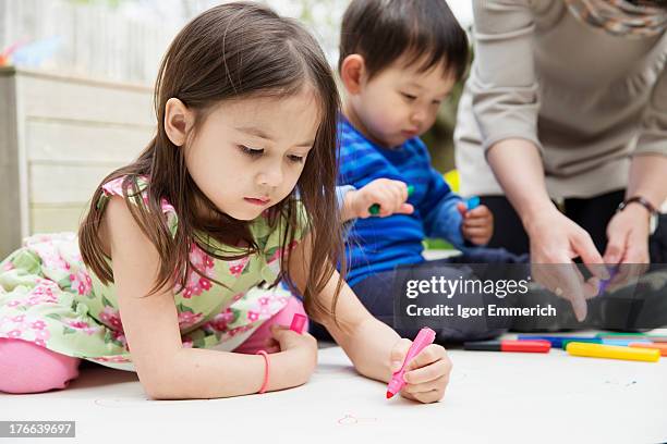 mother and two children drawing in garden - japanese people lesson english stock pictures, royalty-free photos & images