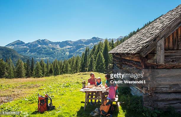 austria, salzburg country, family having rest at altenmarkt zauchensee - berghütte stock-fotos und bilder