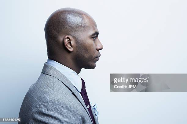studio portrait of businessman in profile - grey suit fotografías e imágenes de stock