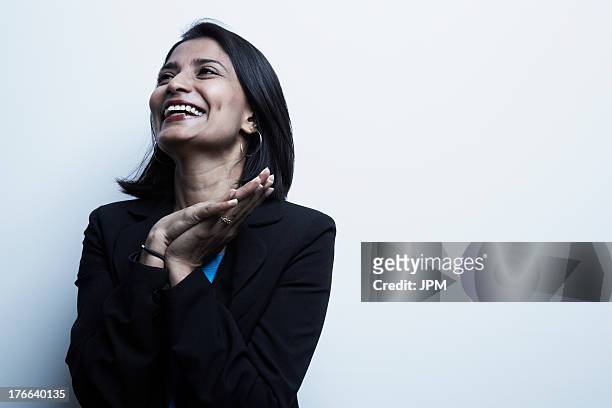 studio portrait of businesswoman smiling - indian faces stock-fotos und bilder