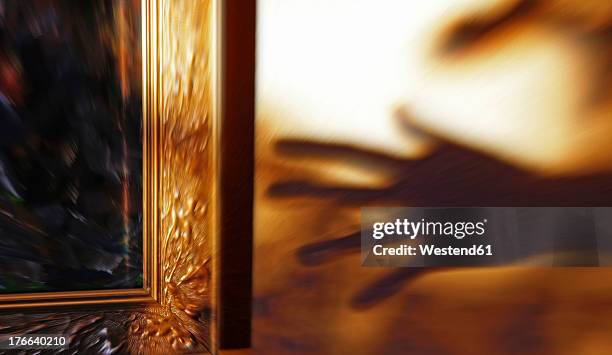 shadow of hand stealing piece of art - stolen painting stock pictures, royalty-free photos & images