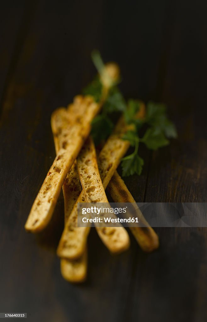 Breadsticks on wooden table, close up