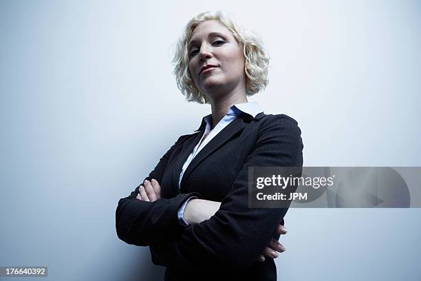 studio portrait of businesswoman with arms crossed - female smug stock pictures, royalty-free photos & images