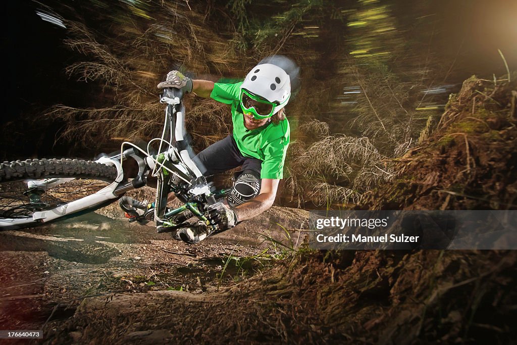 Mountain biker riding narrow track