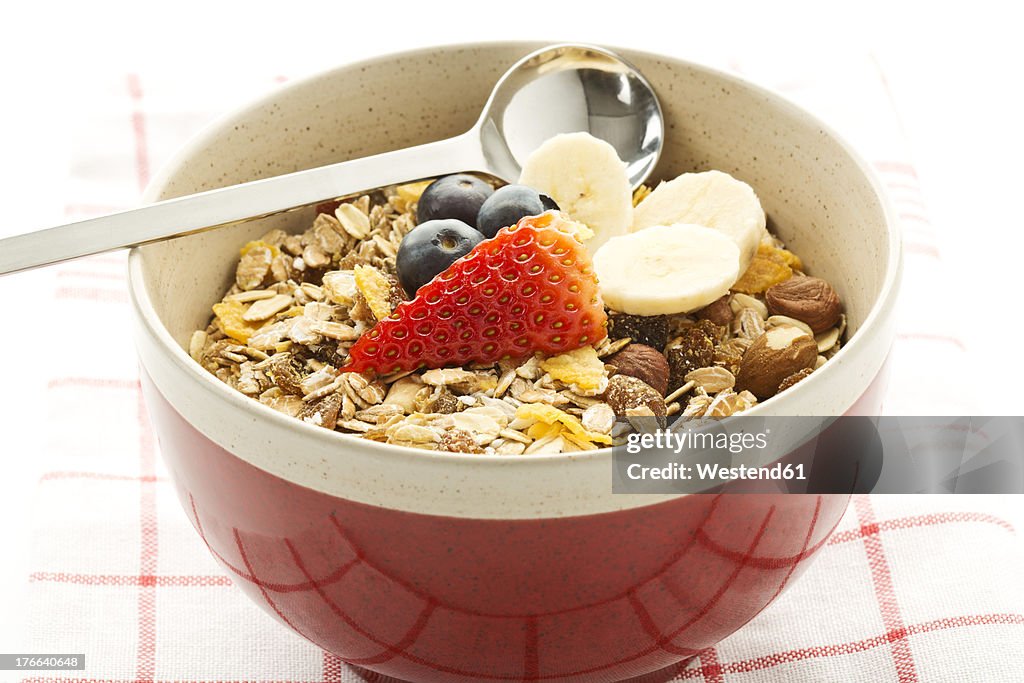 Breakfast bowl of cereals with banana, blueberry and strawberry