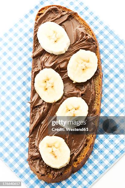 bread topped with nutella and banana slices - chocolate spread stock pictures, royalty-free photos & images