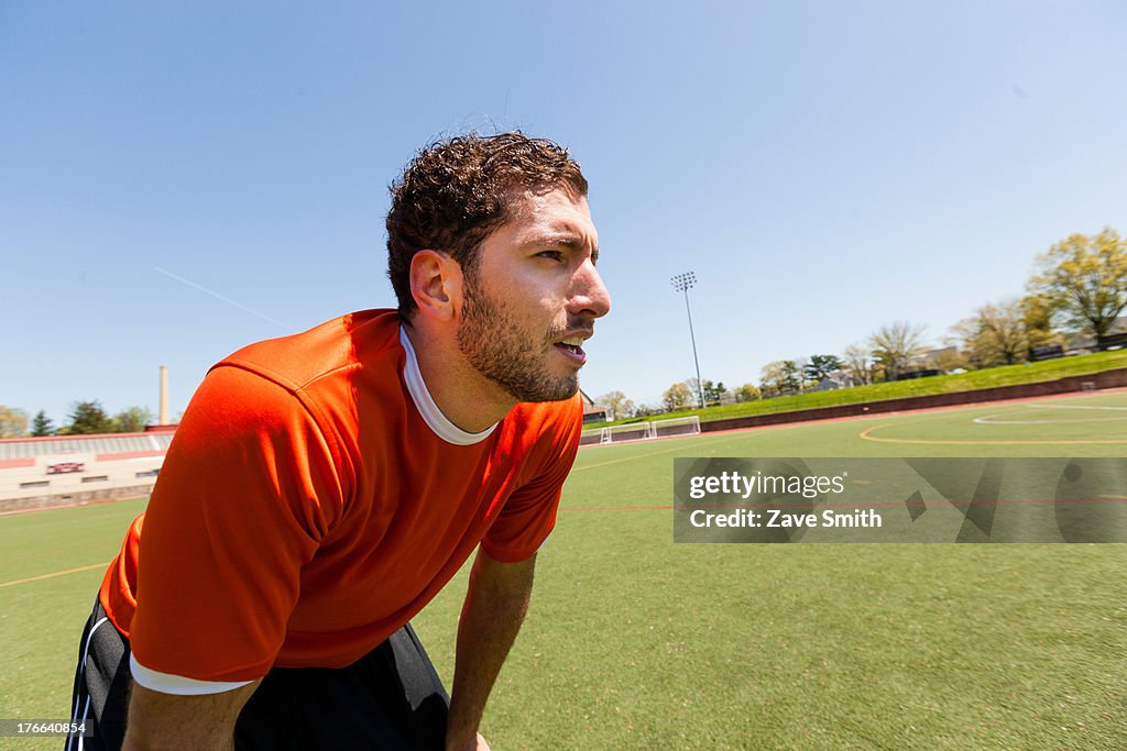 Soccer player taking a break on pitch