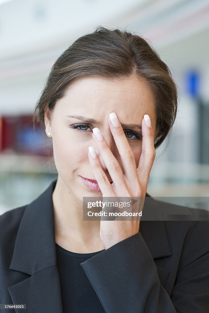 Stressed businesswoman looking at camera