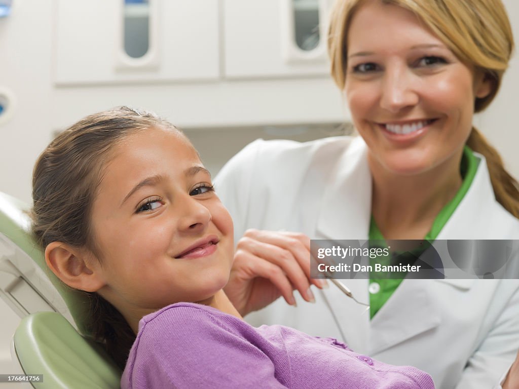 Dentist and young patient smiling, portrait