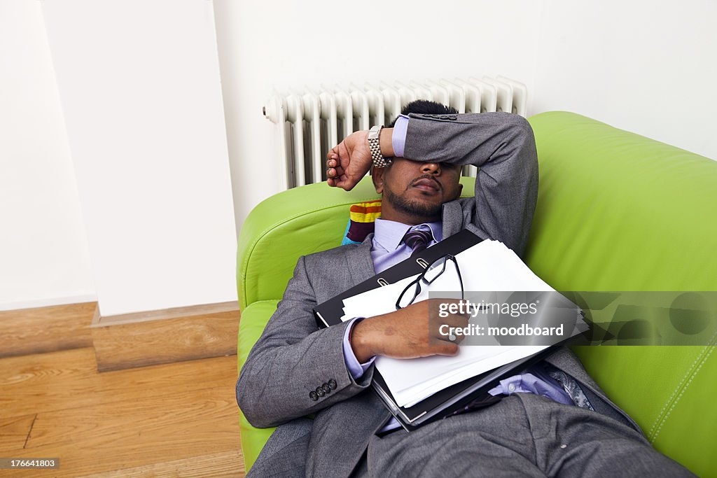 Businessman sleeping on a sofa