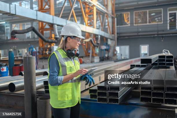female engineer doing quality control in a factory - steel mill stock pictures, royalty-free photos & images