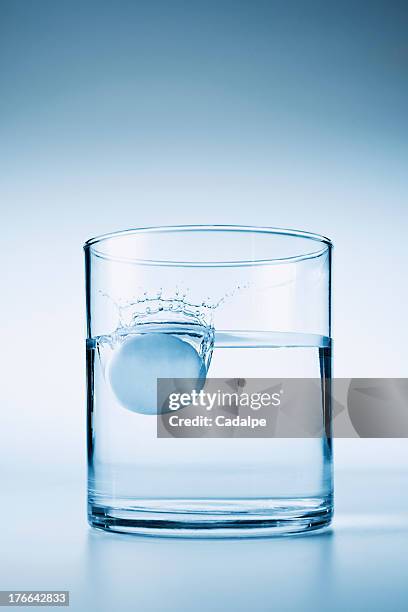 tablet falling in glass of water - cadalpe stock pictures, royalty-free photos & images