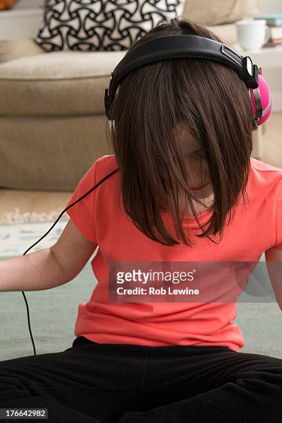 girl wearing headphones, looking down - emo girl stock pictures, royalty-free photos & images