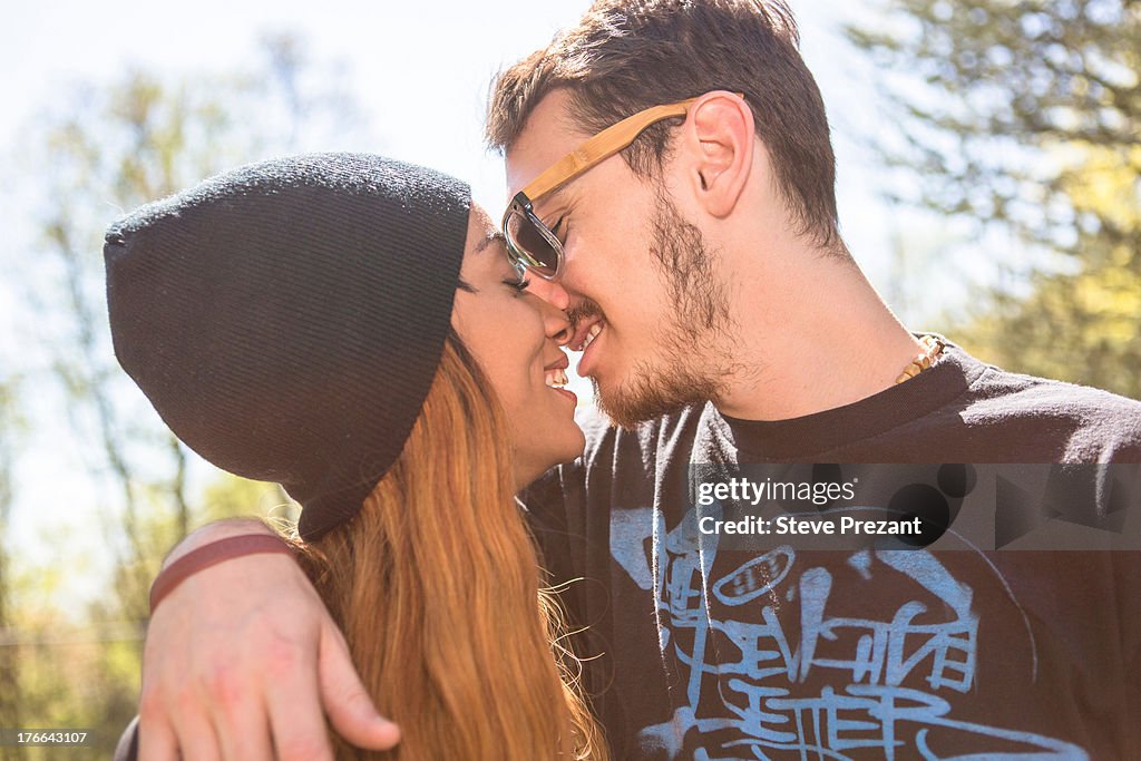 Couple kissing, woman wearing knit hat